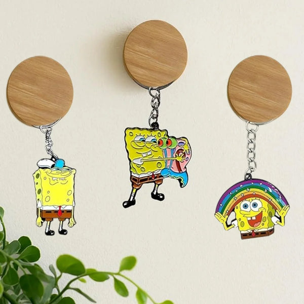 A set of three SpongeBob SquarePants cartoon keychains with round wooden discs and silver chains.