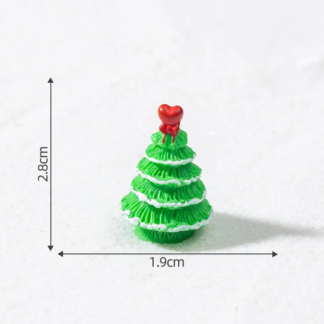 A small, green, three-dimensional Christmas tree charm with a red heart topper.