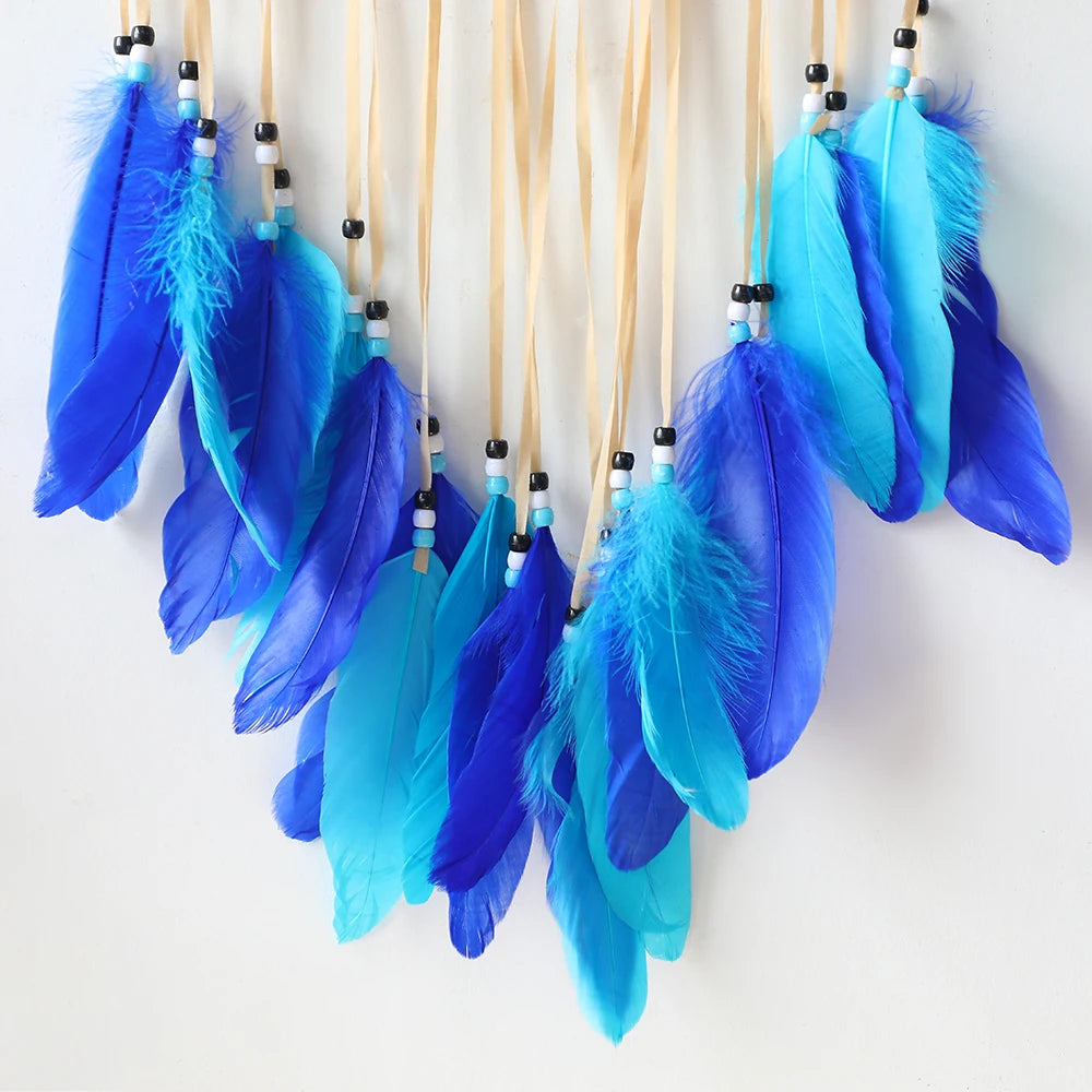 Handmade boho evil eye dream catcher wall decor featuring vibrant blue and turquoise feathers on twine