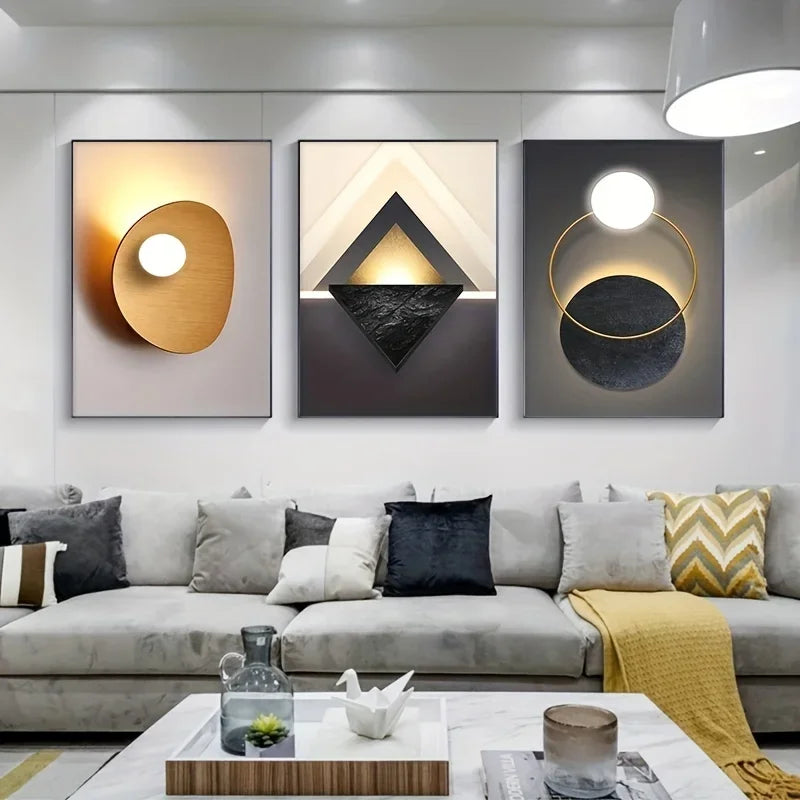 Modern geometric canvas wall art featuring three framed abstract pieces with gold and black tones.