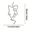 Minimalist abstract face metal wall art showing a stylized, flowing line design.