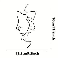 Minimalist abstract face metal wall art showing a stylized, flowing line design.