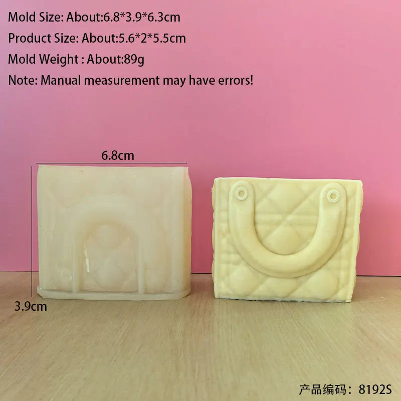 A rectangular silicone mold shaped like a handbag is shown against a pink background.