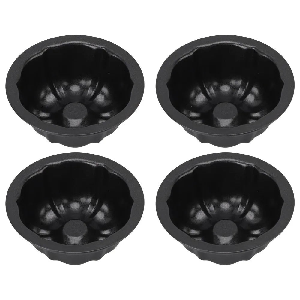 Set of four black nonstick mini fluted cake pans