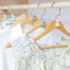 A set of space-saving hanger connector hooks is displayed hanging on a wooden rack.