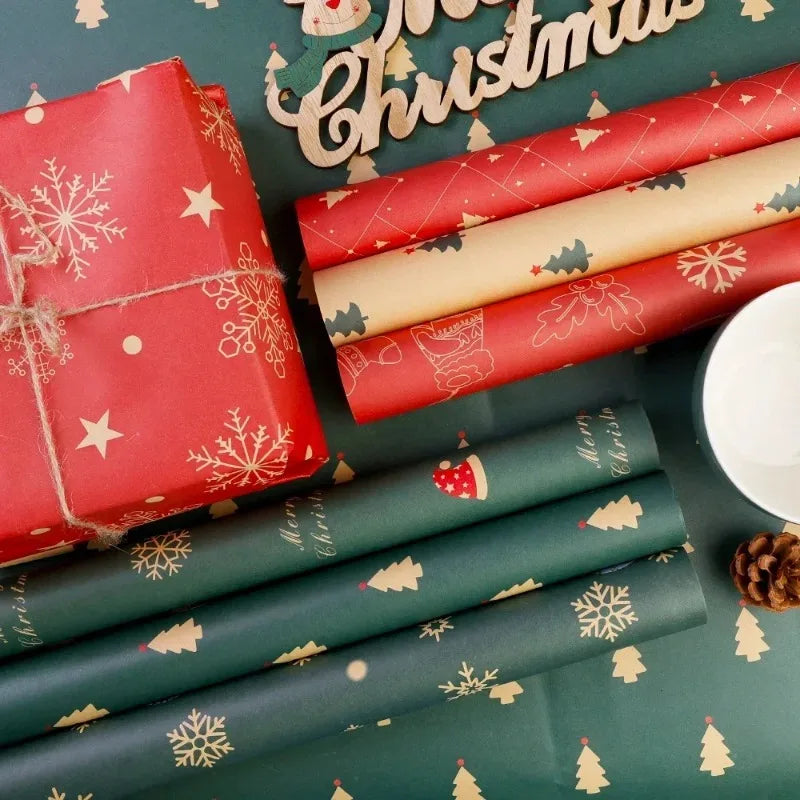 Red and green kraft wrapping paper rolls with festive Christmas designs and a red gift box.