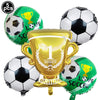 A collection of soccer balls and a gold trophy balloon for a sports-themed party decoration set.