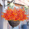 A vibrant bouquet of orange and red artificial daisies in a woven basket hanging on a wooden structure.