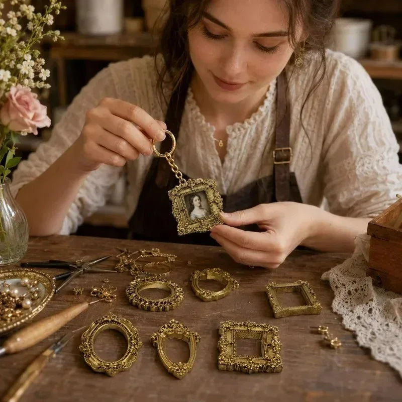 A woman is crafting a set of vintage gold resin mini photo frames on a wooden table.