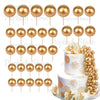A set of gold and rose gold foam cake toppers, including various sized round discs.