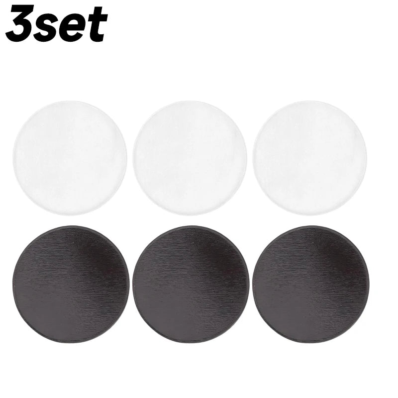 A set of three round acrylic fridge magnets in white and dark gray colors.