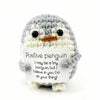 A handmade crochet penguin doll with a positivity card attached.