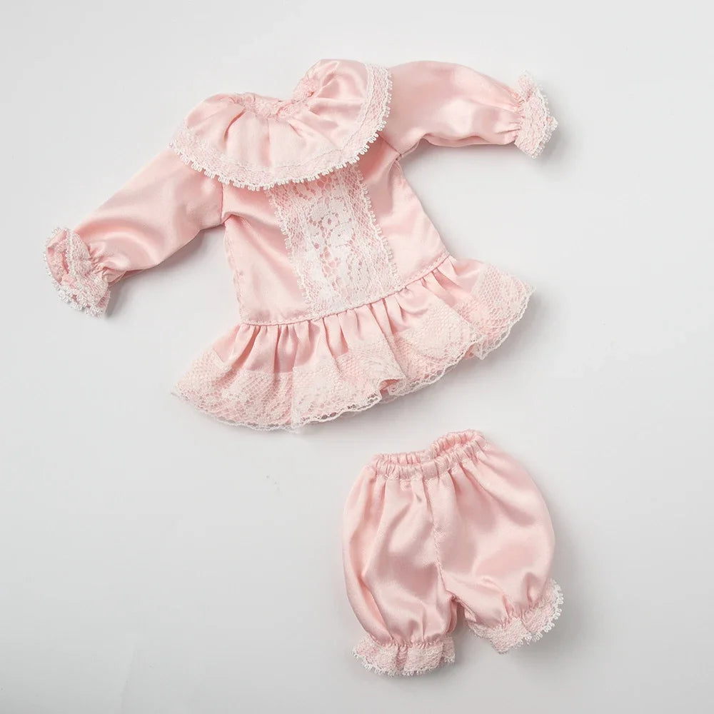 Pink vintage lace pajama set for a doll featuring ruffled sleeves and trim