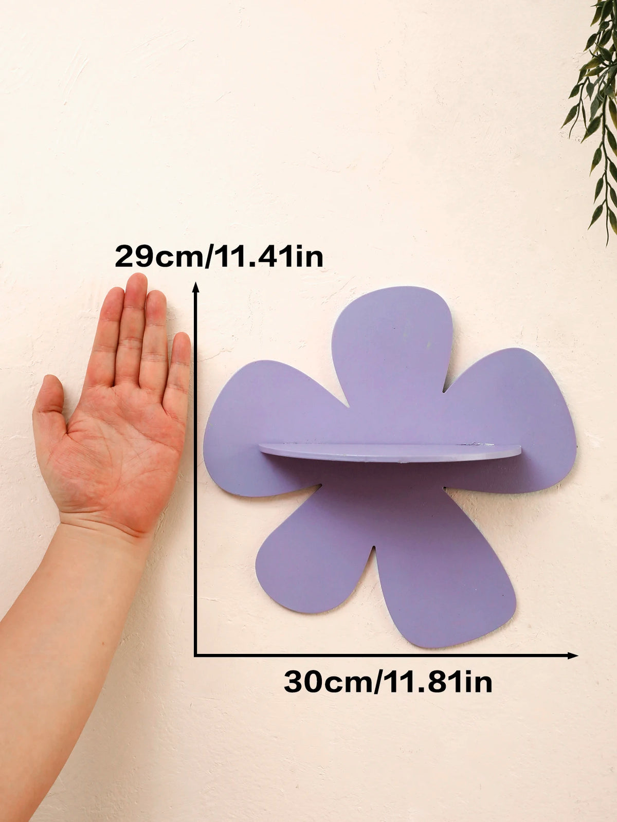 A hand is shown next to a purple cherry-shaped wooden wall shelf, measuring 29cm by 30cm.