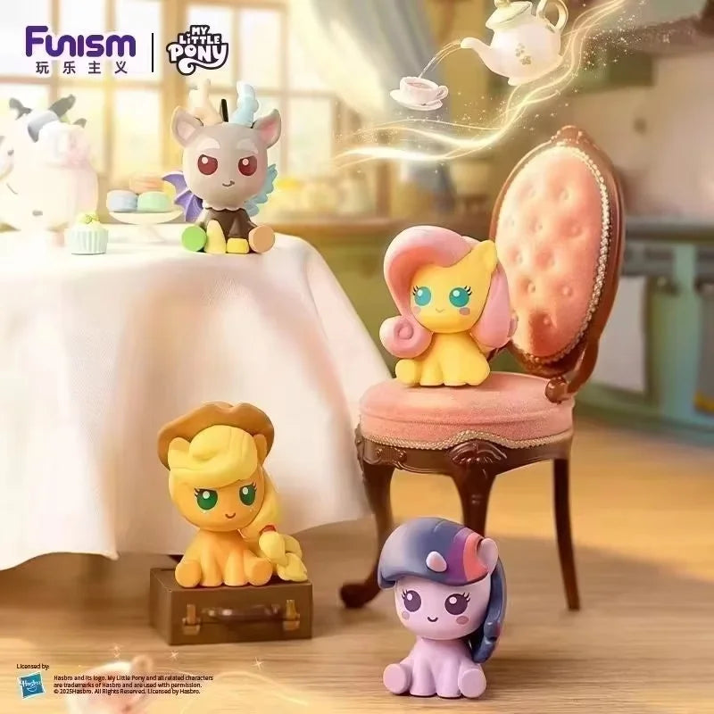 A collectible figurine of a pony character with pink and yellow features sitting on a wooden box.
