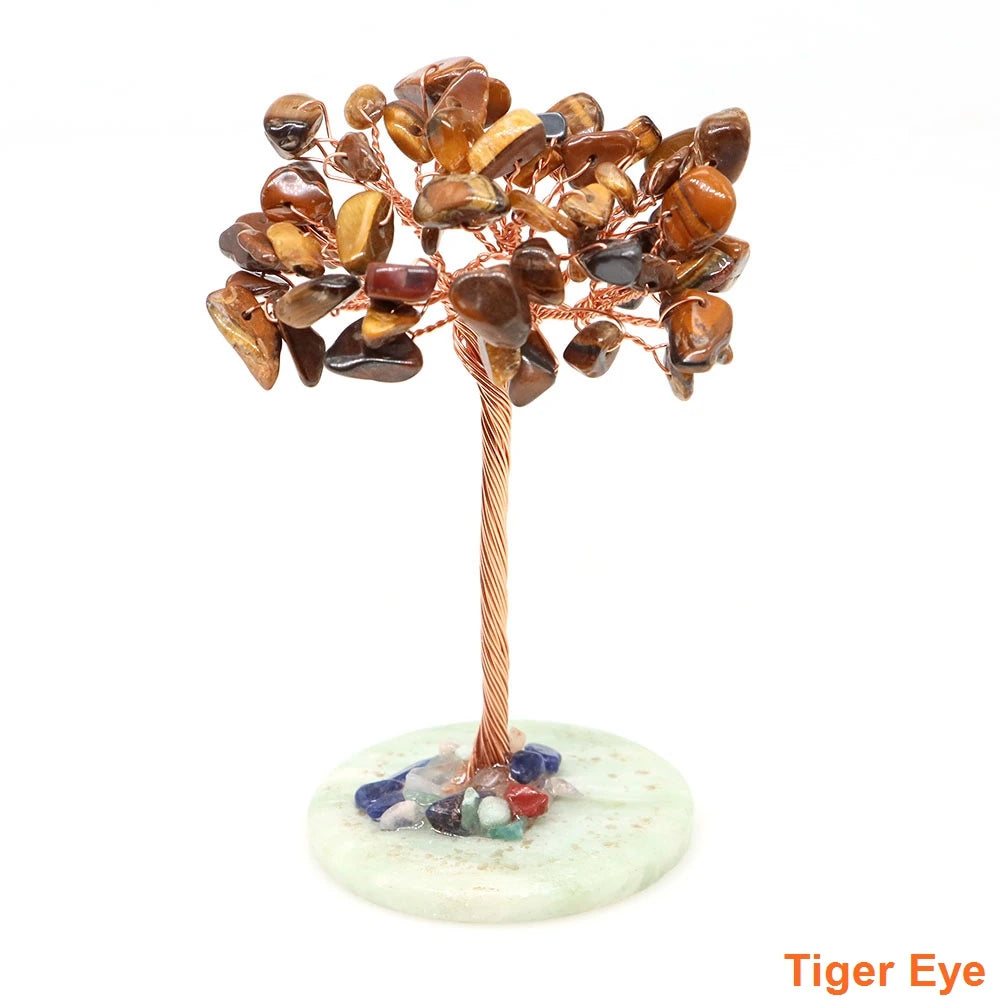 Natural crystal money tree decor featuring amber and brown stones wrapped with copper wire on a light base