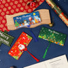 A festive cash gift box with a wooden tray and Christmas-themed cards and ornaments.