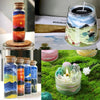 Various glass candles filled with colored sand pigment and wax, displayed in various arrangements.