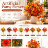 A collection of vibrant artificial pansy flowers in various colors like orange, red, and yellow displayed in a white pot.