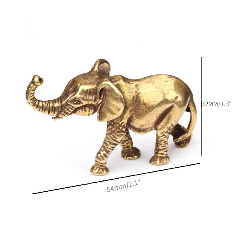 A small antique bronze elephant figurine used as a tea pet or table ornament.