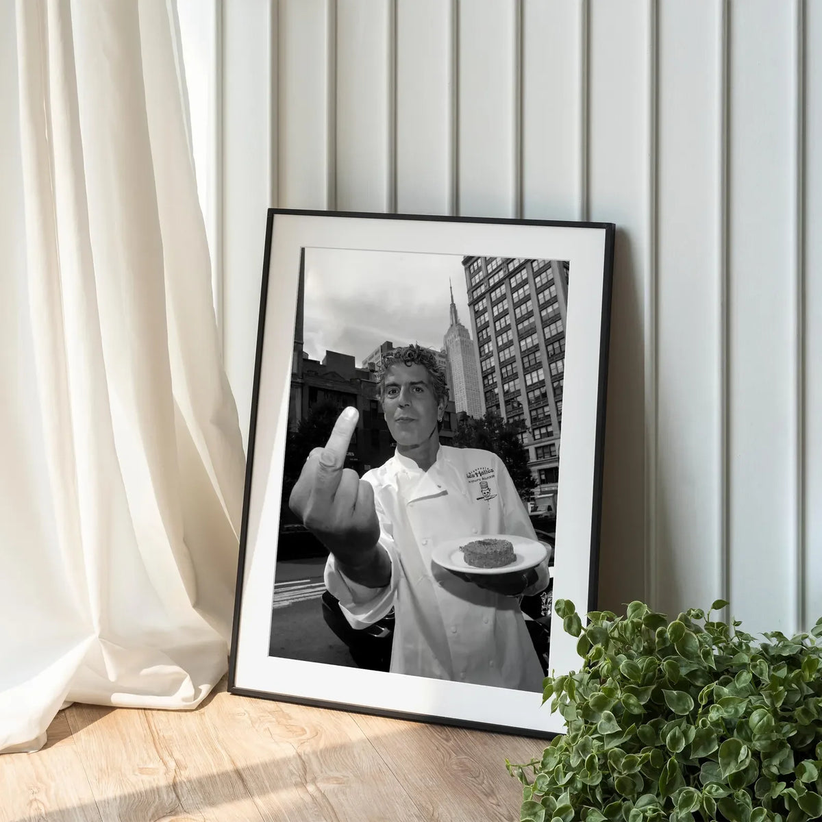 Black and white photograph of a man making a finger point gesture displayed in a framed print.