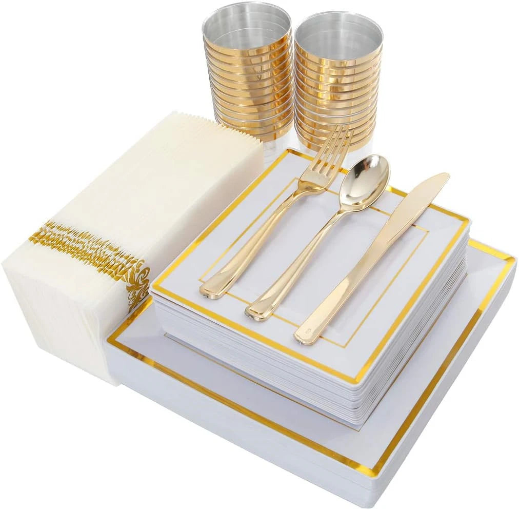 A set of gold plastic dinnerware, including plates and cutlery, is displayed on a white tray.
