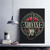 A black framed poster featuring a grunge design of the Nirvana band logo and guitar in red and white tones.