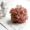A bouquet of pink and gold silk hydrangea stems with vintage burnt edge petals