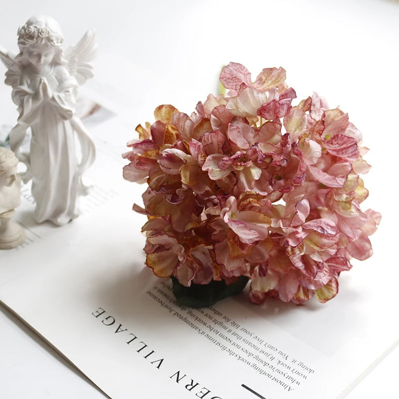 A bouquet of pink and gold silk hydrangea stems with vintage burnt edge petals