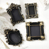 Four ornate black and gold vintage baroque resin hanging photo frames displayed on a white background.