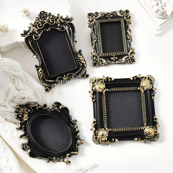Four ornate black and gold vintage baroque resin hanging photo frames displayed on a white background.