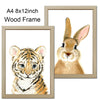 A watercolor painting of a baby tiger in a wooden frame.
