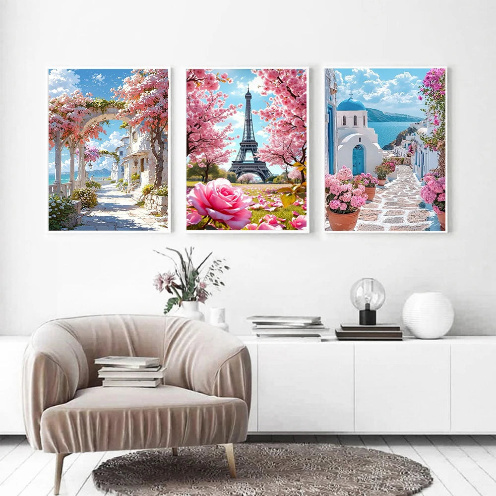 Three framed diamond paintings featuring the Eiffel Tower and pink cherry blossoms against a blue sea background