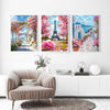 Three framed paintings featuring the Eiffel Tower and pink cherry blossoms on a white wall.