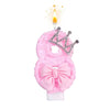 Pink bow crown number 8 birthday candles set with a lit flame