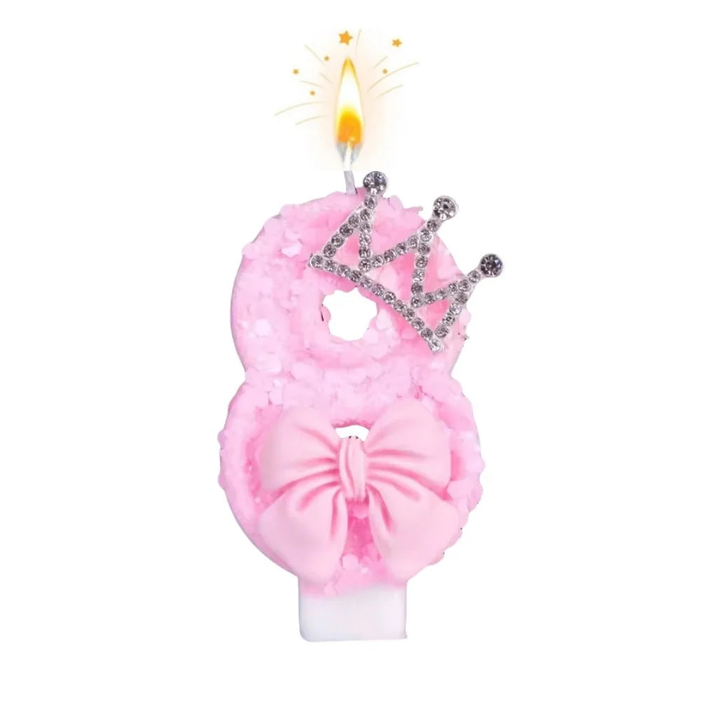 Pink bow crown number 8 birthday candles set with a lit flame