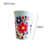A light blue disposable cup decorated with colorful floral patterns for serving.