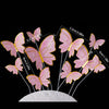 A set of five pink butterfly cake toppers with various sizes and gold accents displayed on a white surface.