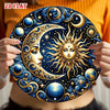 A hand holds a vintage celestial sun and moon metal wall sign featuring gold and blue designs against a dark background.