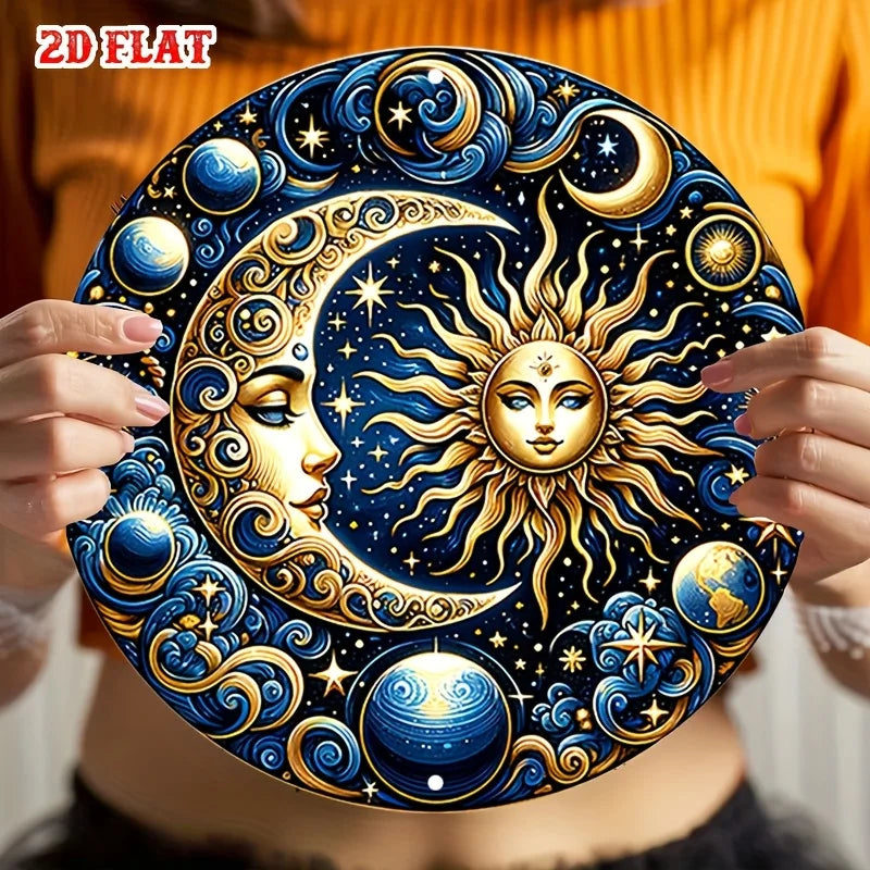 A hand holds a vintage celestial sun and moon metal wall sign featuring gold and blue designs against a dark background.