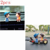 A set of two cute couple balloon car ornaments featuring a boy and a girl.