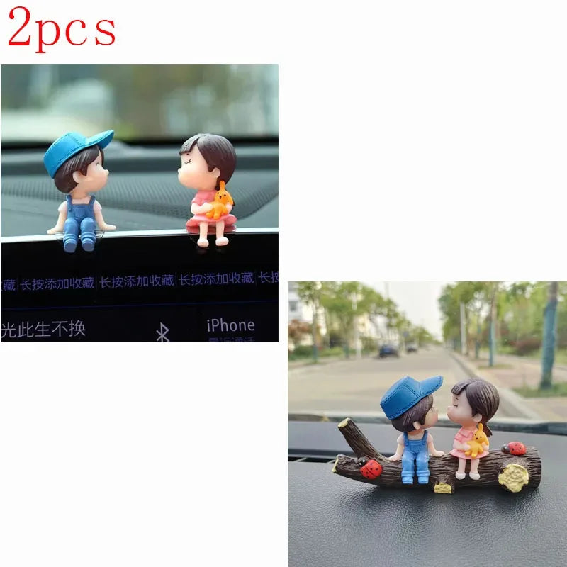 A set of two cute couple balloon car ornaments featuring a boy and a girl.