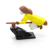A figurine of a witch with brown hair and yellow clothing is shown in a dynamic pose, part of a flying carriage decor set.