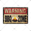 A vintage industrial tin sign with a warning label that reads WARNING BBQ ZONE.