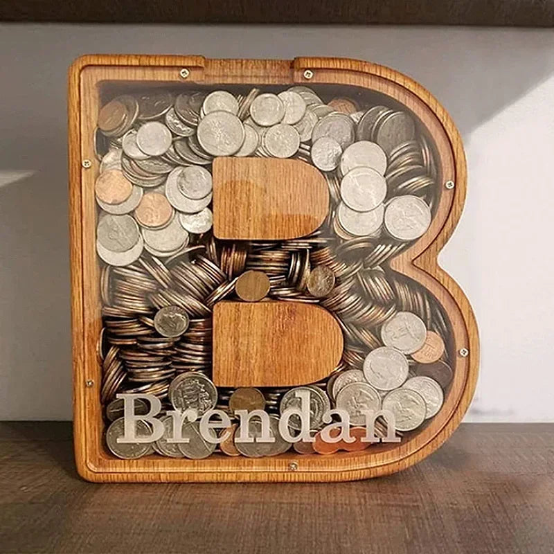 Alphabet wooden piggy bank coin box shaped like the letter B with coins inside