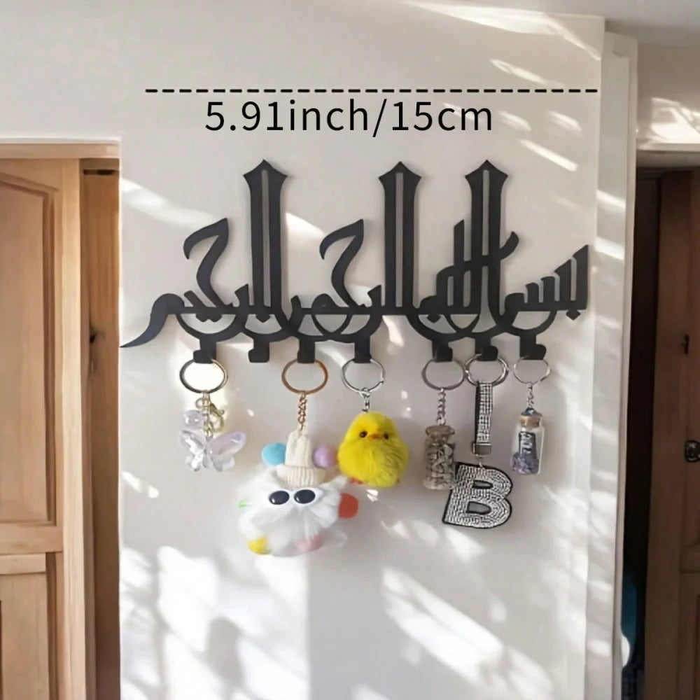 Black Islamic Arabic blessing key holder with hooks mounted on a white wall