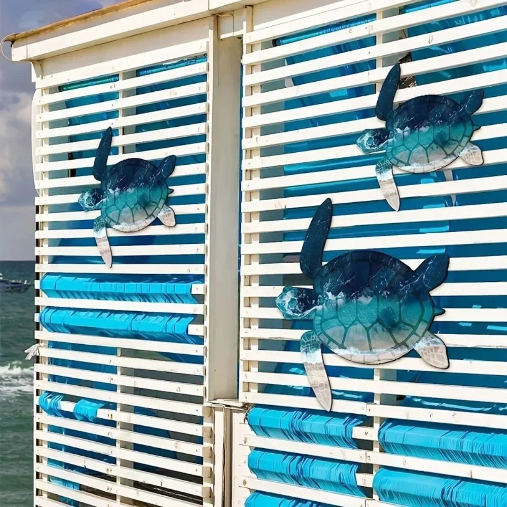 A vertical wall sculpture featuring teal and blue sea turtle shapes mounted on a white slat background.