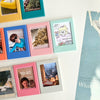 A collection of colorful magnetic photo frames displaying various memories and images.