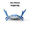 A small blue crab-shaped desk organizer with a white body, designed to hold pens or phones.