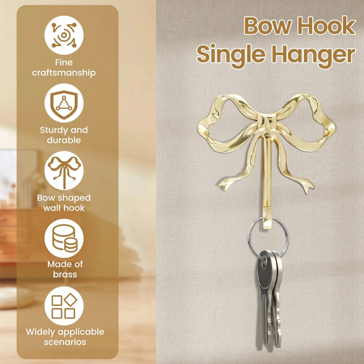 A gold brass bow hook single hanger with a keyring hanging against a neutral background.